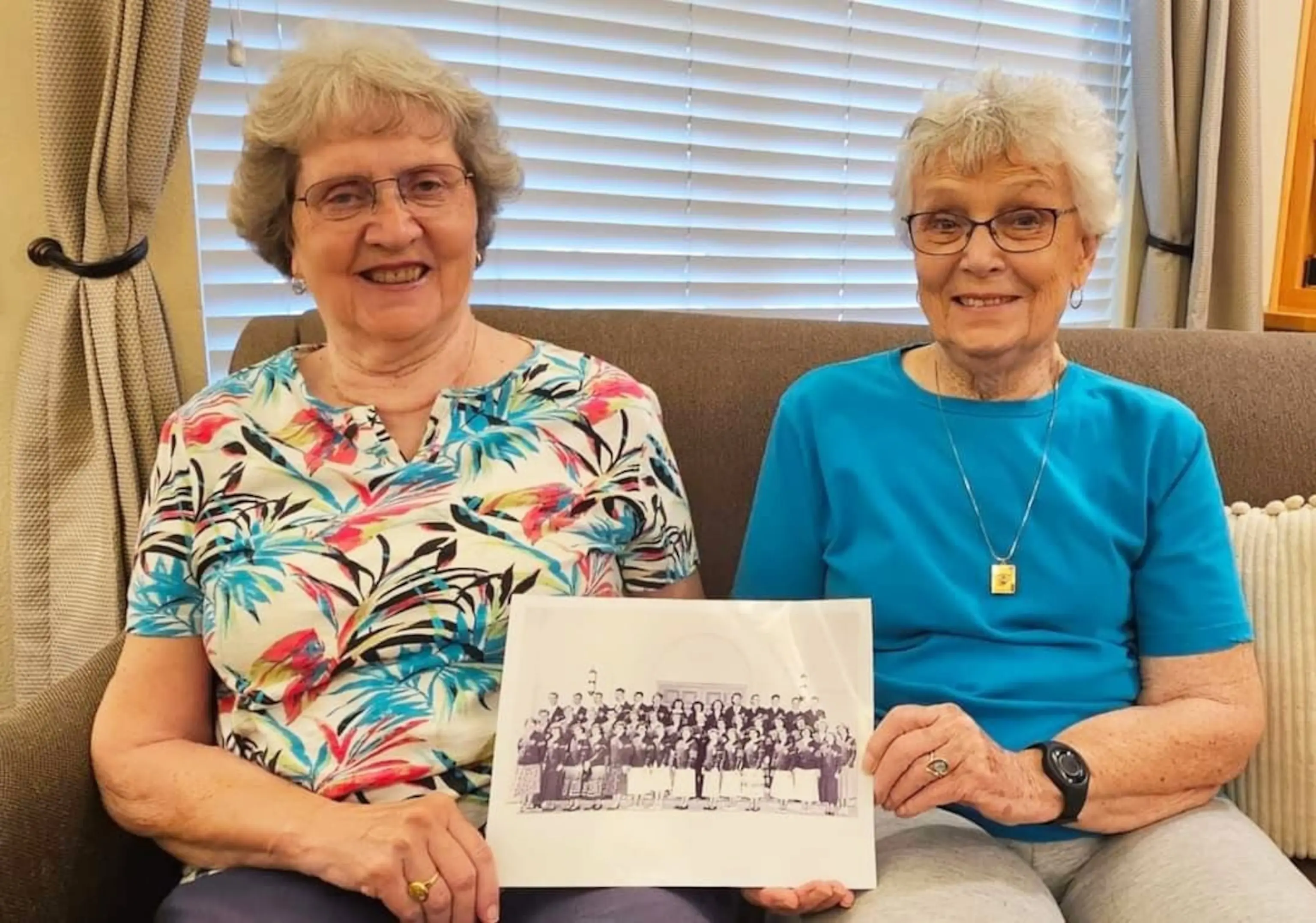 PHOTO: Sylvia Crane, left, and Joan Harris hold a class photo from Mt. St. Mary’s Academy in Grass Valley, California.