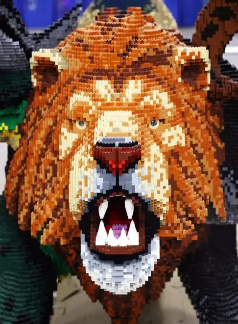 A lion appears at Brick Fest Live featuring life-sized models made from Legos, hands-on activities, and a meet-and-greet with Manny from the 