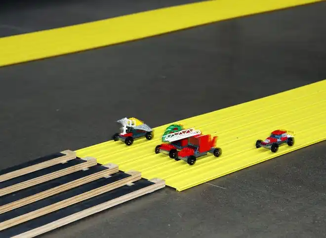 Kid-built cars race to the finish line at Brick Fest Live featuring life-sized models made from Legos, hands-on activities, and a meet-and-greet with Manny from the 