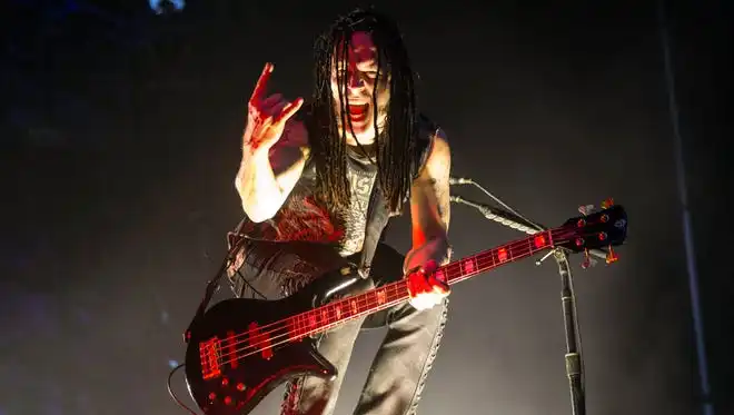 John Moyer poses for the audience during a Disturbed performance at Louder Than Life on Sunday. 10/2/16