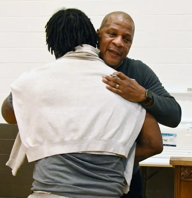 Darryl Strawberry, a former Major League Baseball right-fielder who is an ordained minister, hugs an incarcerated man at the Roxbury Correctional Institution after sharing some of the challenges he faced in his life and praying with the inmates. (Kim Hairston/Staff)