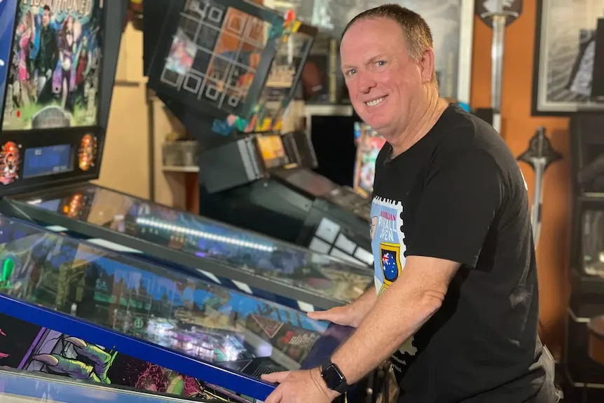 Doctor John Cosson at a pinball machine