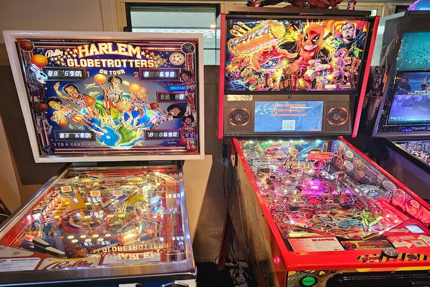 Harlem pinball machine next to deadpool pinball machine