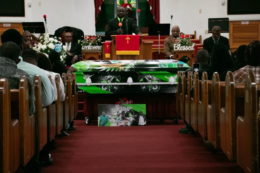 Mourners gather before Ba'Shawn Pickney's casket at his funeral service at Olivet Missionary Baptist Church in Lake City on Feb. 17. Pickney, 47, died Feb. 7, due to injuries sustained during a motorcycle accident. (Jackson Castellano/WUFT News)