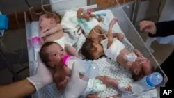 FILE - Medics prepare premature babies for transport to Egypt after they were evacuated from Al Shifa hospital in Gaza City to a hospital in Rafah, Gaza Strip, Nov. 20, 2023.