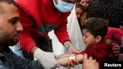 FILE - A Palestinian boy has his arm measured for malnutrition at a medical tent set up by MedGlobal in cooperation with UNICEF, in Rafah, in the southern Gaza Strip, Feb. 14, 2024.