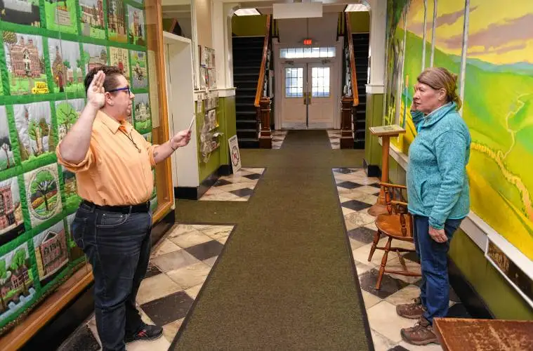 Greenfield Assistant City Clerk Quinn Jaquins, left, swears in Denise Leonard as a member of the Agricultural Commission on Friday in City Hall.