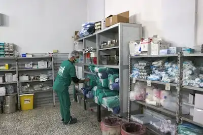 A medic gathers supplies at a hospital in the town of Harim, in Syria's Idlib province. AFP