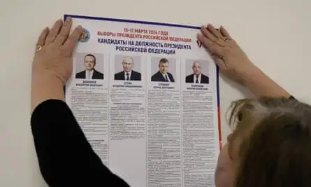 A member of a local electoral commission prepares a polling station on 14 March for the presidential election in Moscow