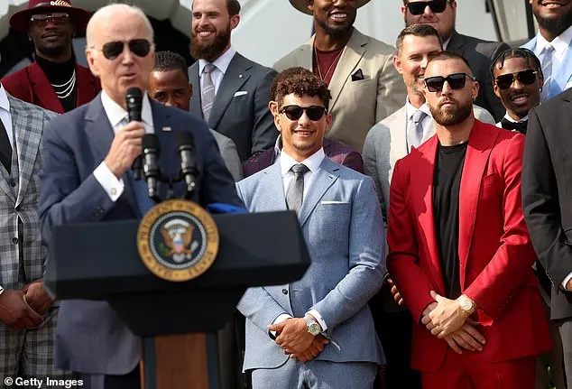 Butker can be seen over Biden’s left shoulder wearing a pro-life tie with his gray suit jacket