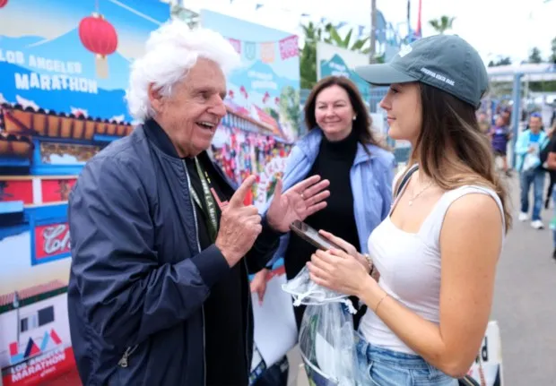 Clara Harter, Southern California News Group reporter, interviews legacy runner Paul Brestyanszky as Paul's wife, Mila Cangelosi listens on Friday, March 15 prior to the 39th Los Angeles Marathon on Sunday, March 17, 2024. (Photo by Dean Musgrove, Los Angeles Daily News/SCNG)