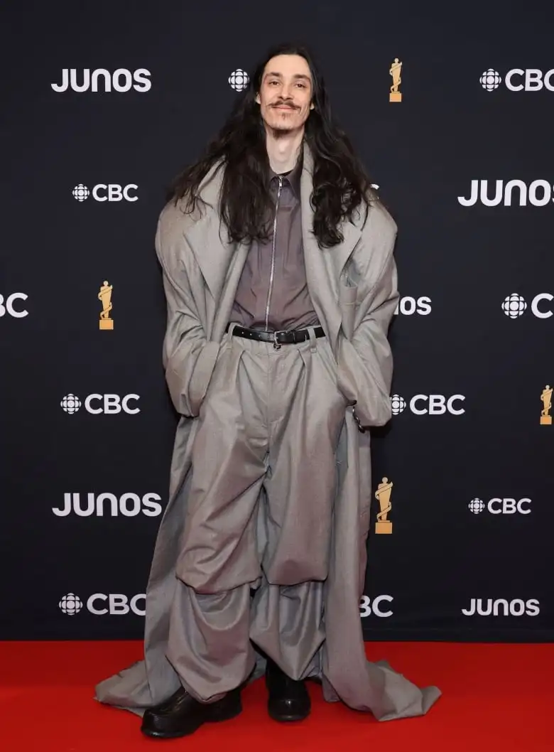 Lubalin on the Juno Awards red carpet wearing a grey oversized coat-and-trouser combo with a zip-up shirt.