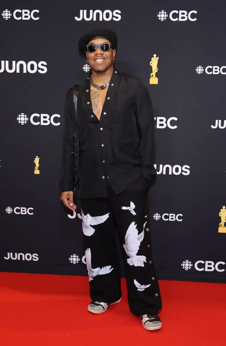 4Korners on the Juno Awards red carpet wearing a black button-up shirt with wide-leg, track pants in a dove print.