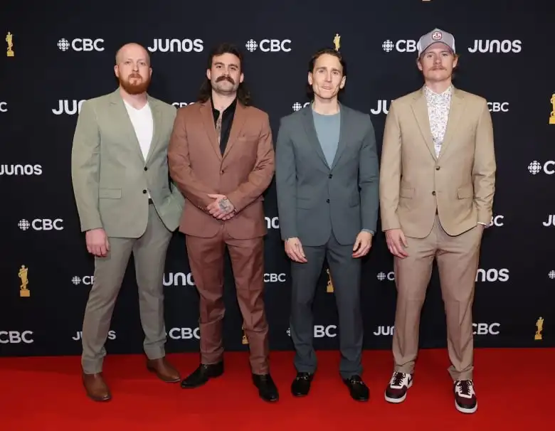 Taylor Abram, Connor Stephen, Bobby Martin and James Barker of James Barker Band on the Juno Awards red carpet wearing single-breasted suits in muted colours.