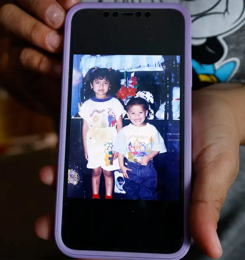 Marcela Chacon Navarrete shows an old photo of her and her brother Jose Fernando Chacon…