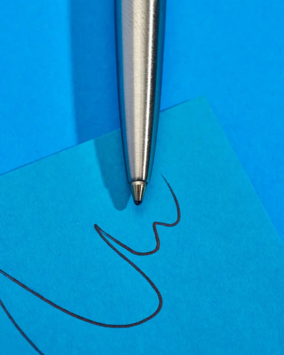 a pen on a blue surface