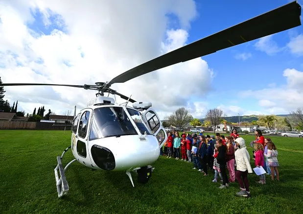 Students get an up-close look at H30 a California Highway Patrol helicopter during First Responder Day at Orchard Elementary School in Vacaville on Thursday. (Chris Riley/The Reporter)