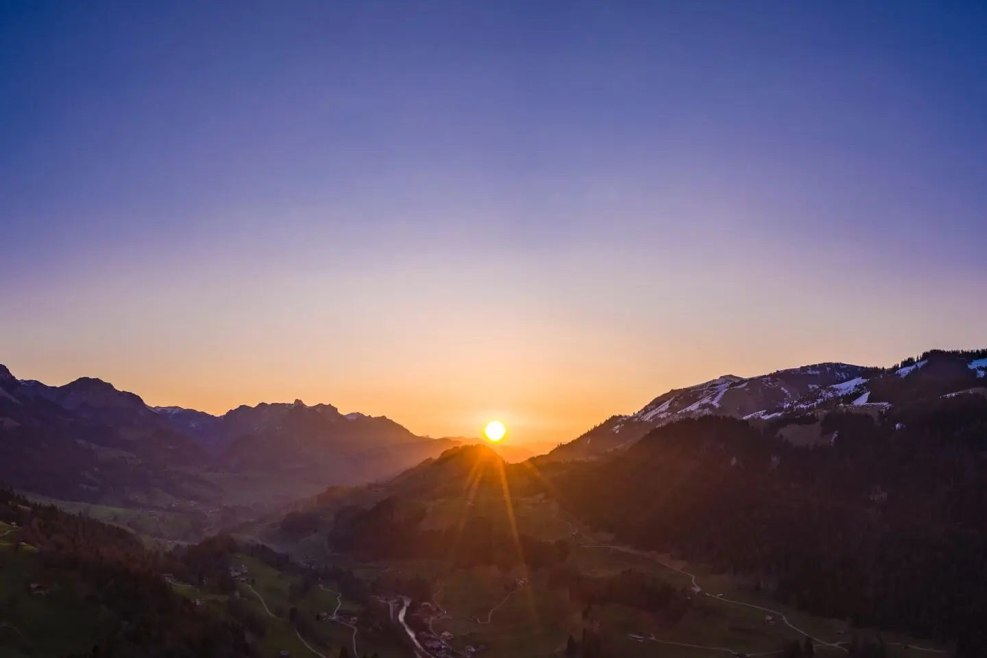 Sun shining over the horizon in Gstaad, Switzerland