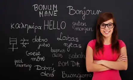 Woman in front of a blackboard with foreign languages