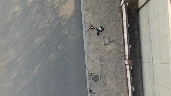 A civilian drone launched from Dandong, China, captures an image of people standing around in the North Korean border city of Sinuiju in this 2020 photo. Captured from Reddit