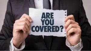 a person holds up a scrap of paper that asks