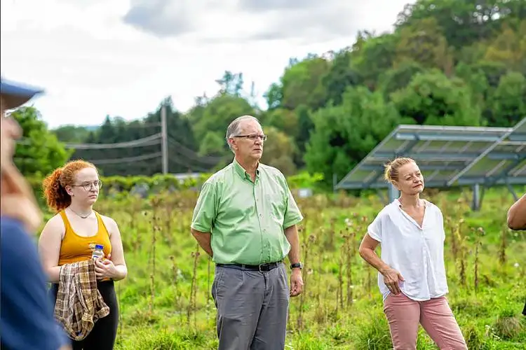 Kevin Jones with students in front of the law school’s solar array located in Royalton, Vt., in an undated photograph. It was the first project completed by the VLGS Energy Clinic, which Jones created in 2014. (Courtesy photograph)