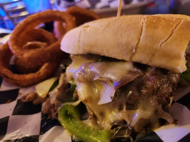 The Shop Bar and Grill's Big Block Cheese Steak consists of shaved ribeye, provolone cheese and sauteed peppers and onions on a hoagie roll. (Mark Koestner - For The News-Herald)