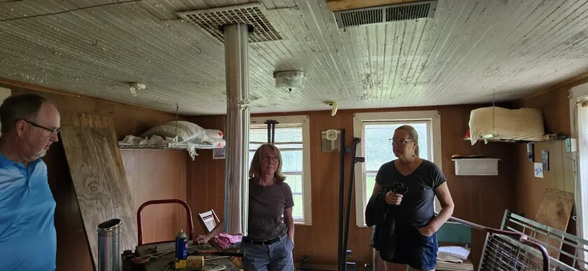 The Ostlie family purchased the cabin and property in 1948. The cabin was covered by siding and its existence was only discovered recently when a piece of siding fell off. The cabin had been leased and used as a hunting shack for many years.   Paul Ostlie and others look over its interior in this undated photo.