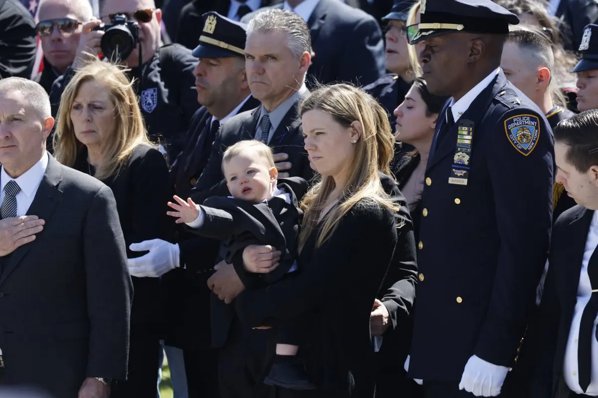 Slain cop's wife at funeral