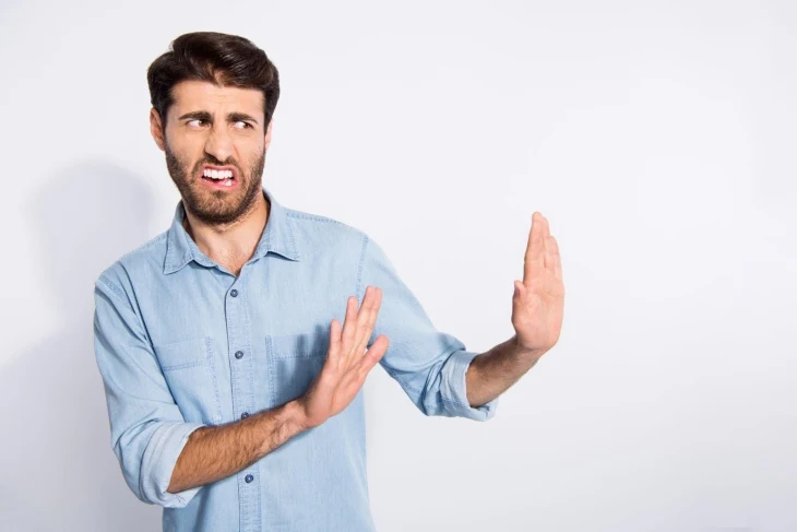 investor using his hands to show avoiding something