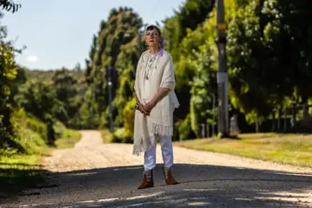 Catherina De Solieux standing on a gravel road lined with trees