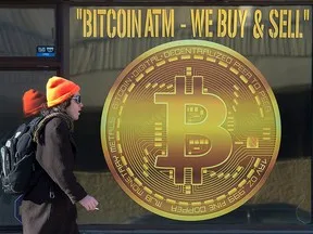 A sign advertises a Bitcoin ATM at a shop in Halifax. The cryptocurrency gains this year have topped 70 per cent.