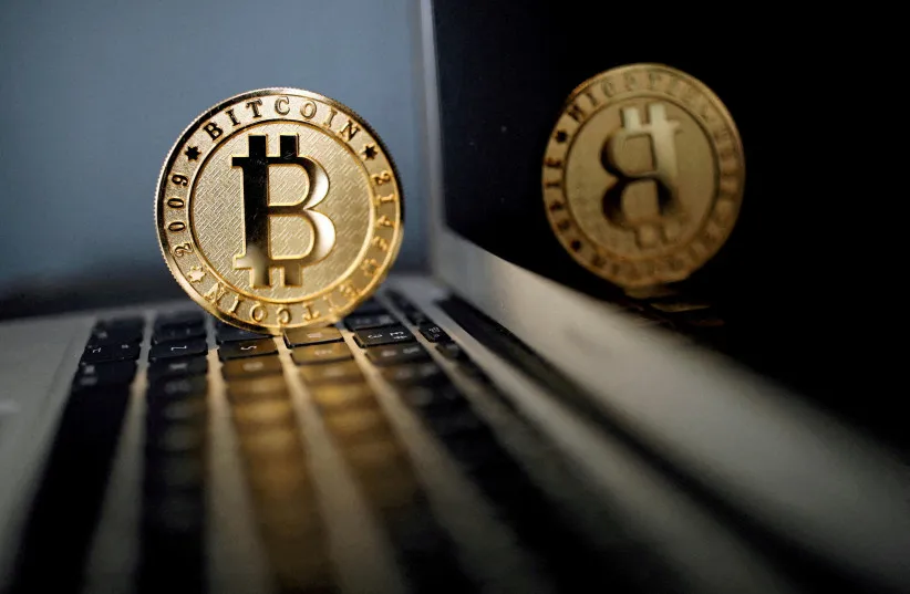 A bitcoin representation is seen in an illustration picture taken at La Maison du Bitcoin in Paris, France, June 23, 2017. (credit: REUTERS/Benoit Tessier/File Photo)