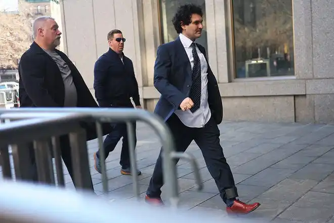 FTX Founder Sam Bankman-Fried arrives at Manhattan Federal Court for a court appearance on March 30, 2023 in New York City. A revised indictment was filed in federal court accusing Bankman-Fried of paying a $40 million bribe to one or more Chinese government officials. He has already been charged with eight criminal counts of fraud, conspiracy, and money-laundering offenses which include making illegal political contributions.