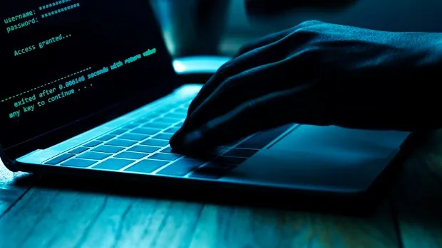 Royalty-free stock photo ID: 1166453734A computer programmer or hacker prints a code on a laptop keyboard to break into a secret organization system. (JARIRIYAWAT/Shutterstock)