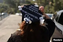 FILE - Student Marie Nangaray Saucedo, 52, takes part in a drive-through graduation at Rio Hondo Community College in Whittier, near Los Angeles, California, May 28, 2021. (REUTERS/Lucy Nicholson)