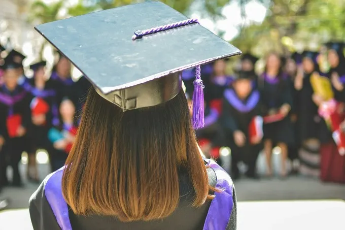 A woman wearing academic cap and dress. Illustration photo by Unsplash