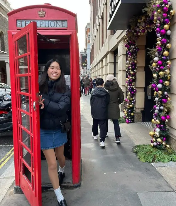 President's Student Ambassador Emmeline Wendel steps out of a red phone booth in London