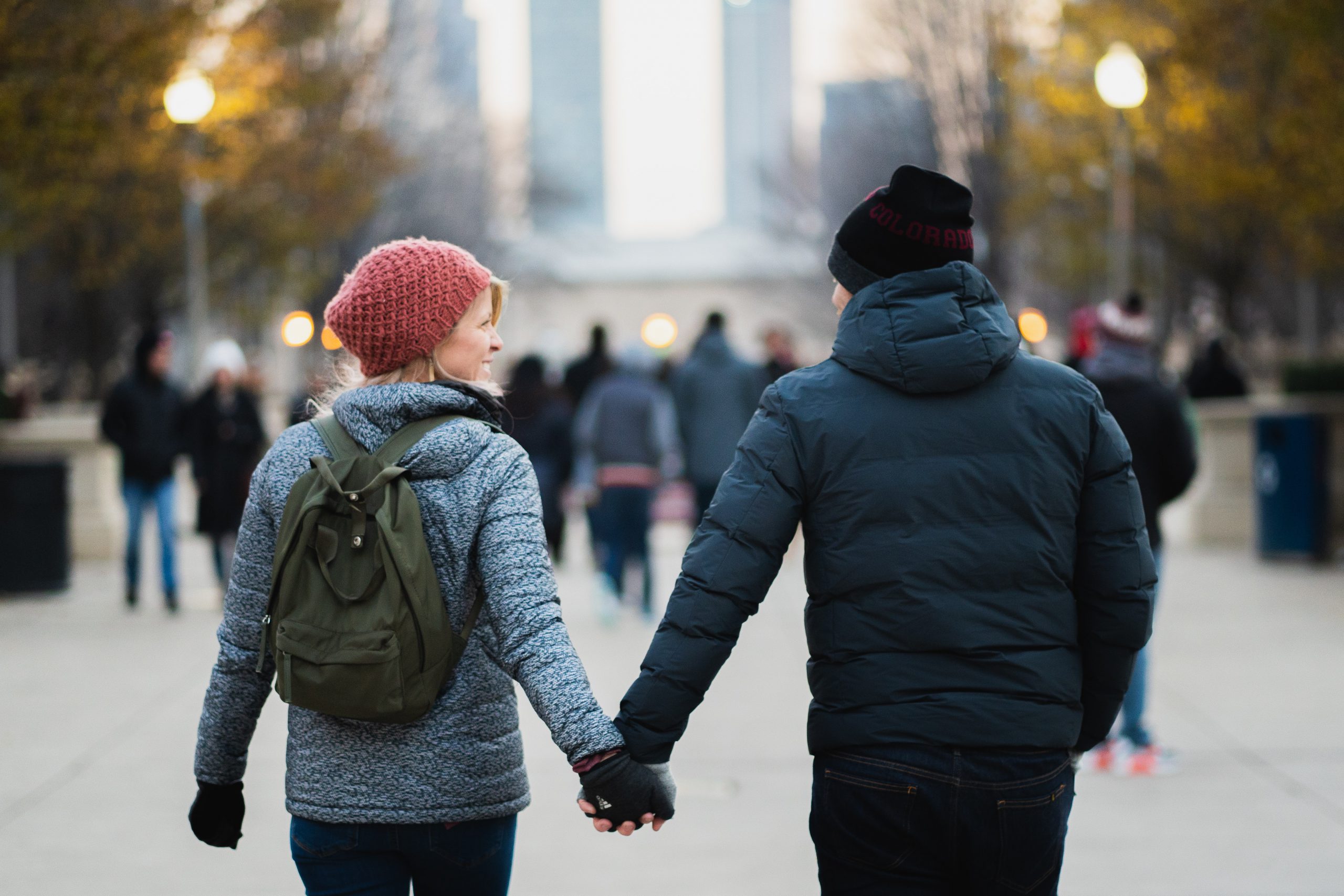 couple holding hands while walking