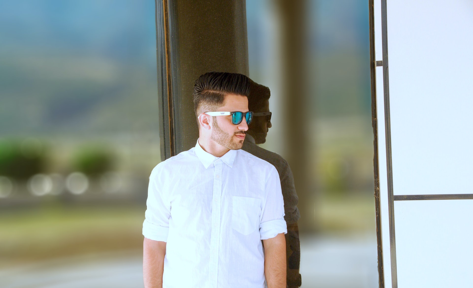 man leaning on glass wall