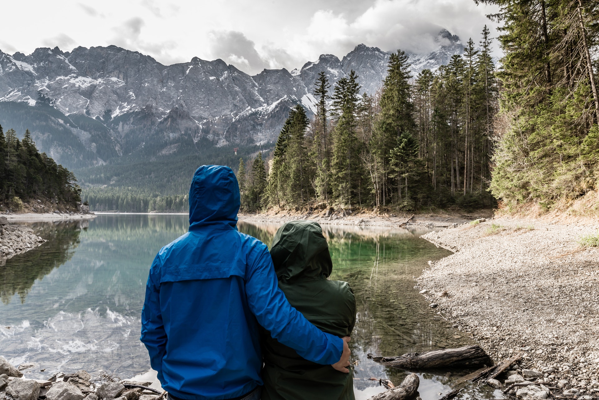 couple standing near body of water