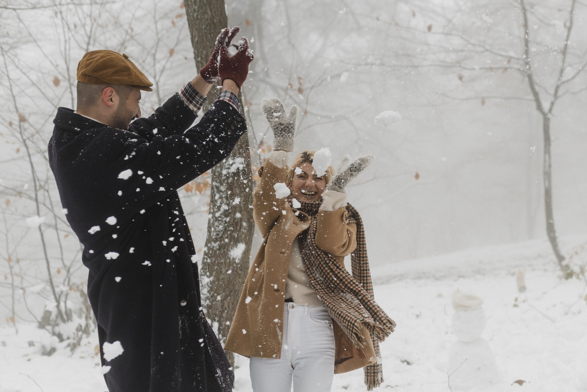 couple playing on the snow