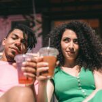 couple holding their juices in a plastic cups