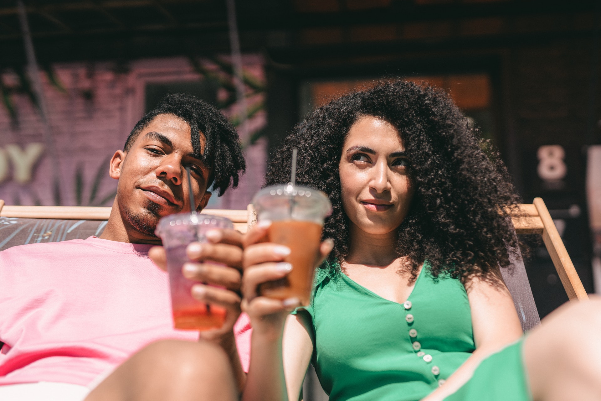 couple holding their juices in a plastic cups