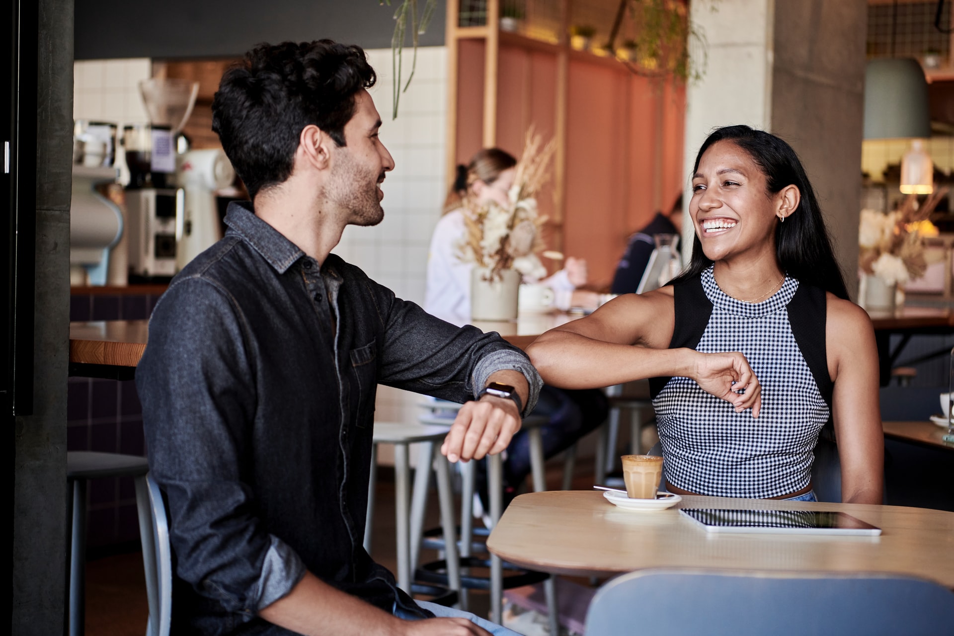 man elbow bumping with woman