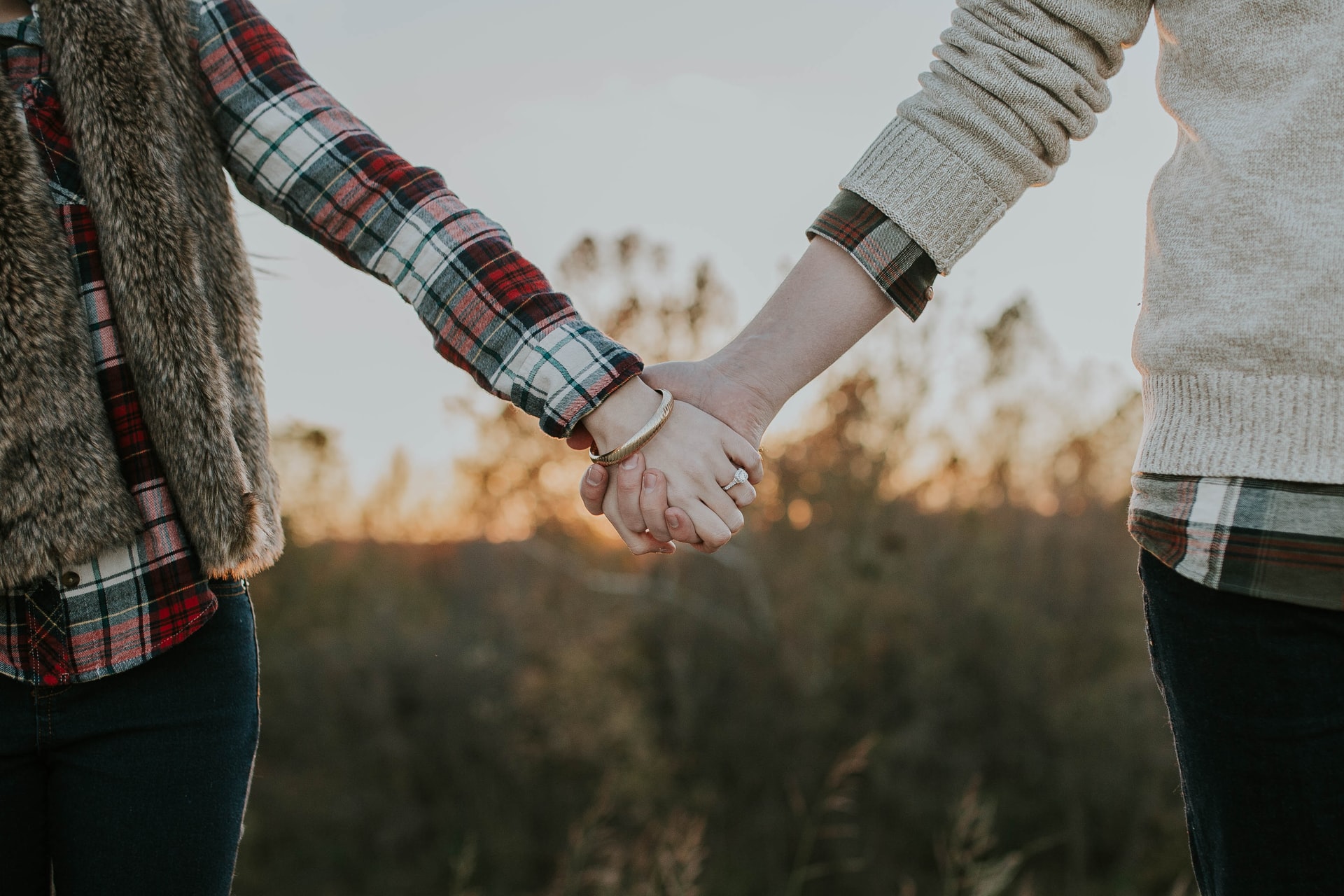 couple holding hands while standing