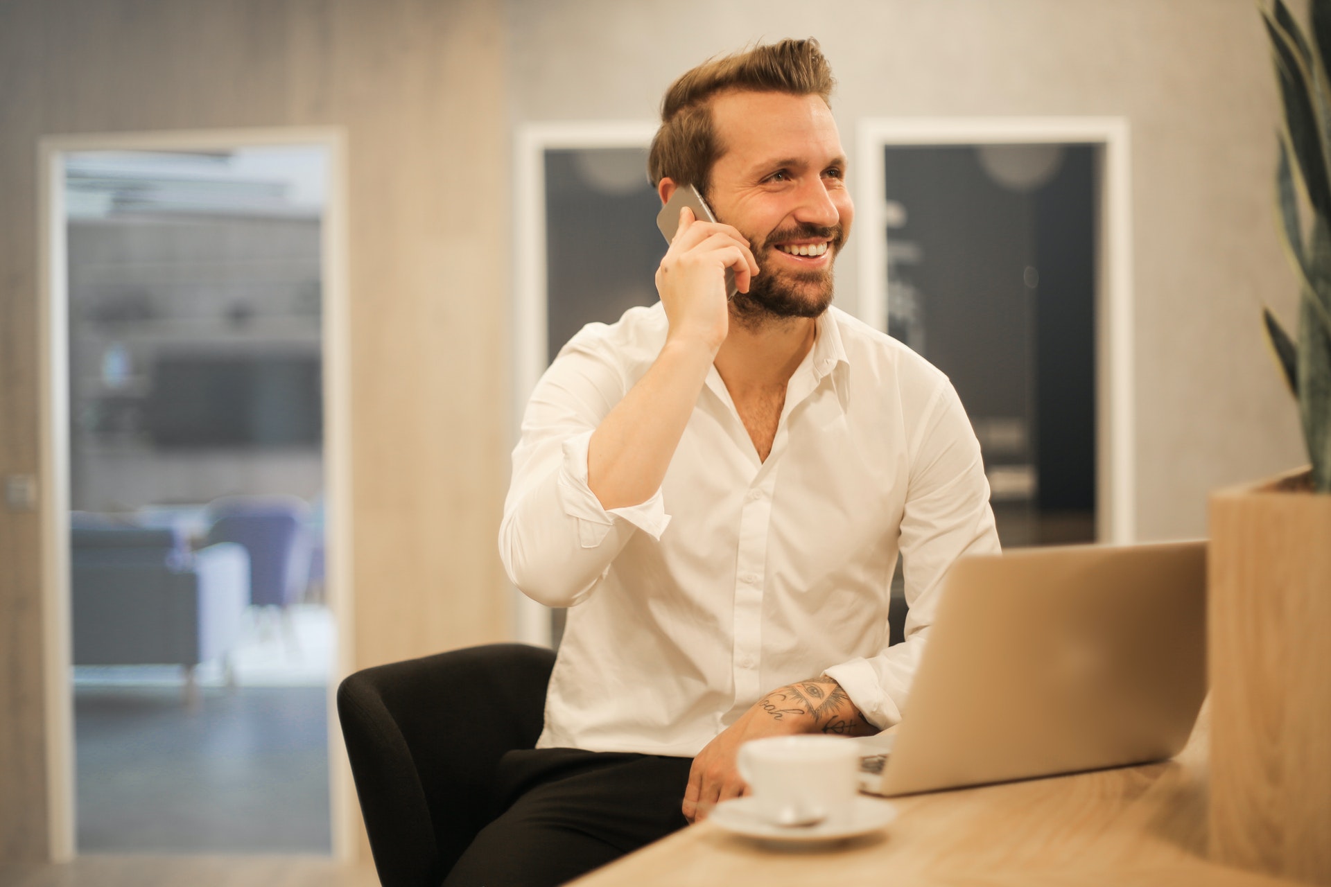 smiling formal male with laptop