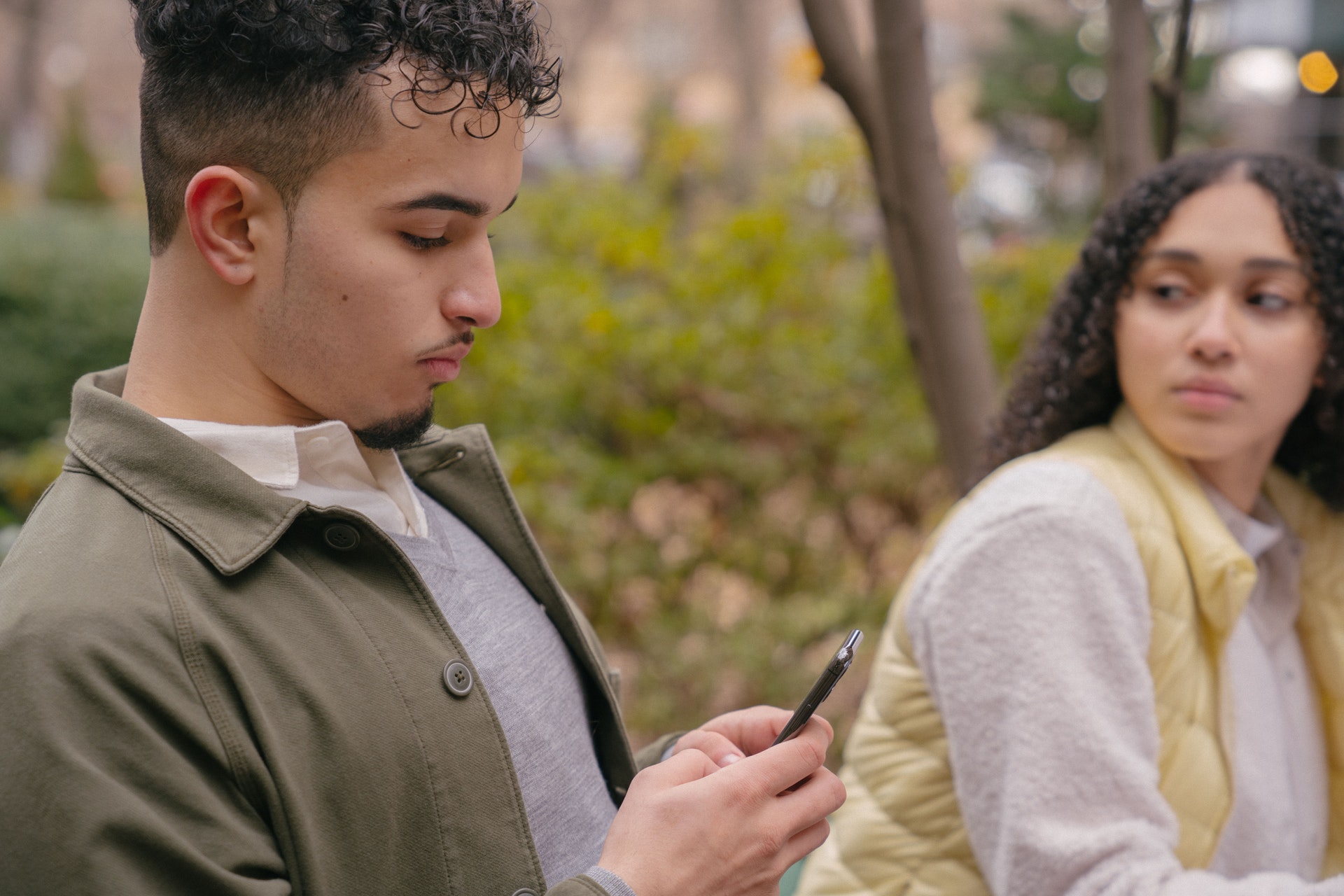 woman looking jealously at boyfriend