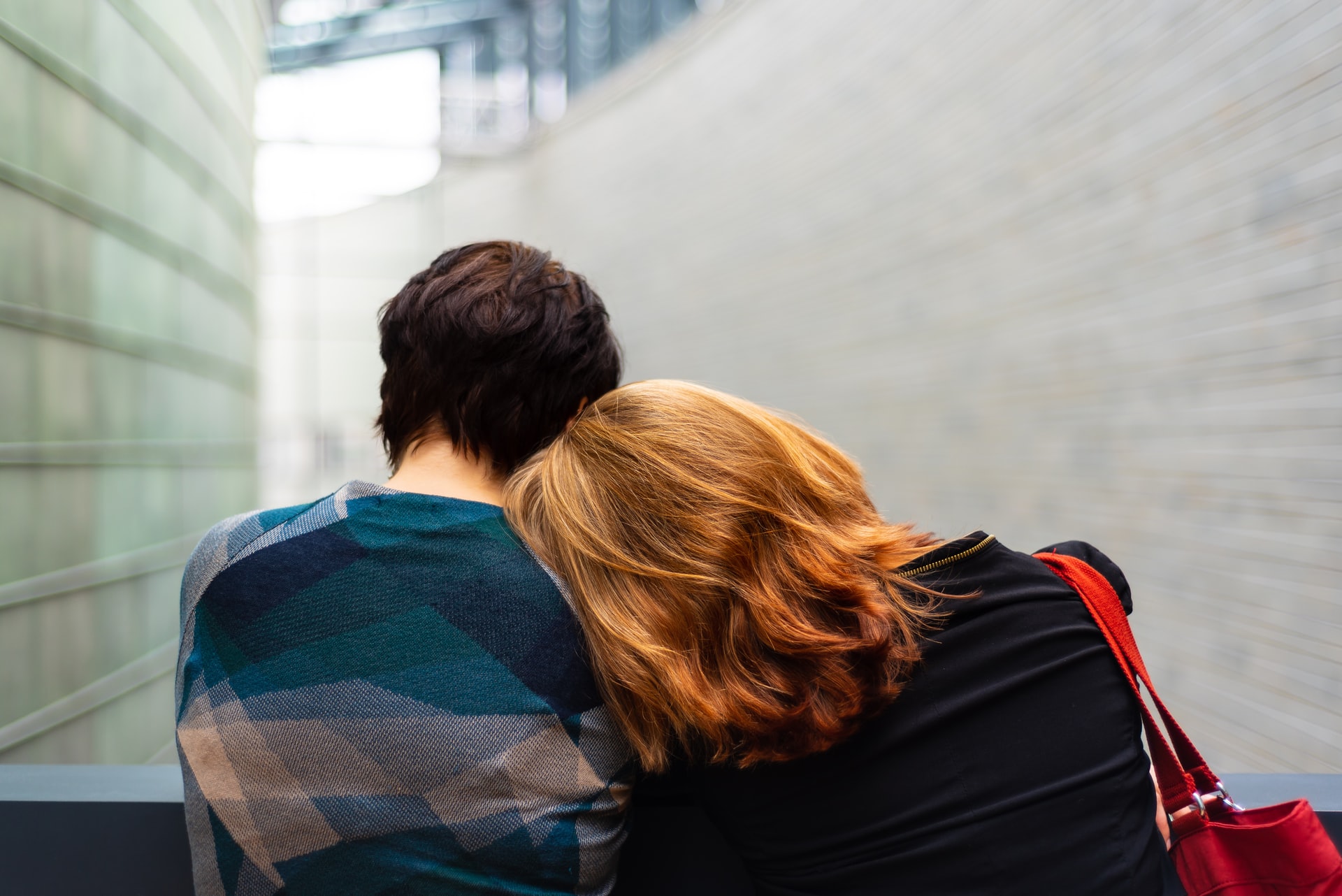 woman rest her head on man's shoulder