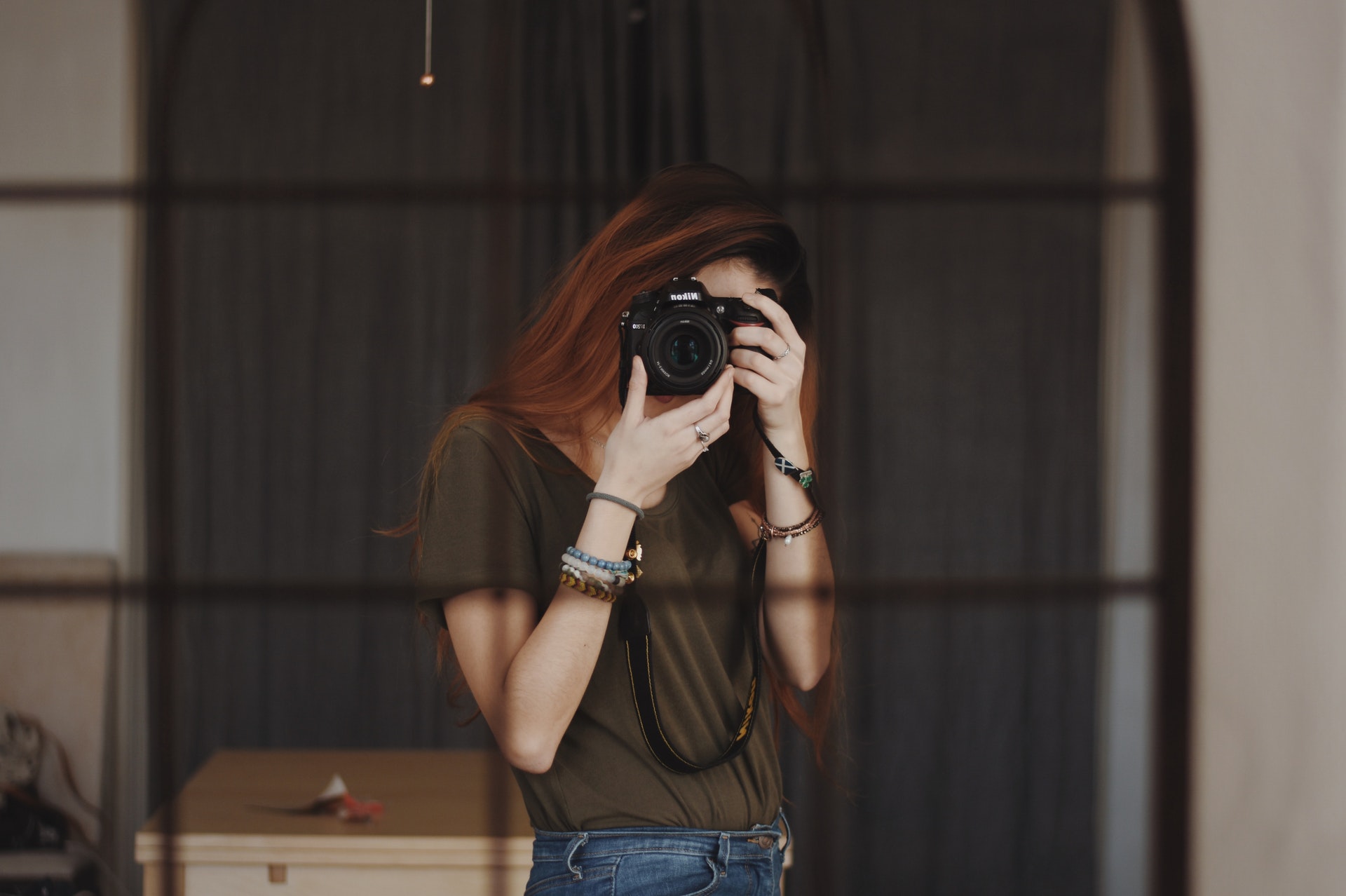 woman taking picture of herself in the mirror